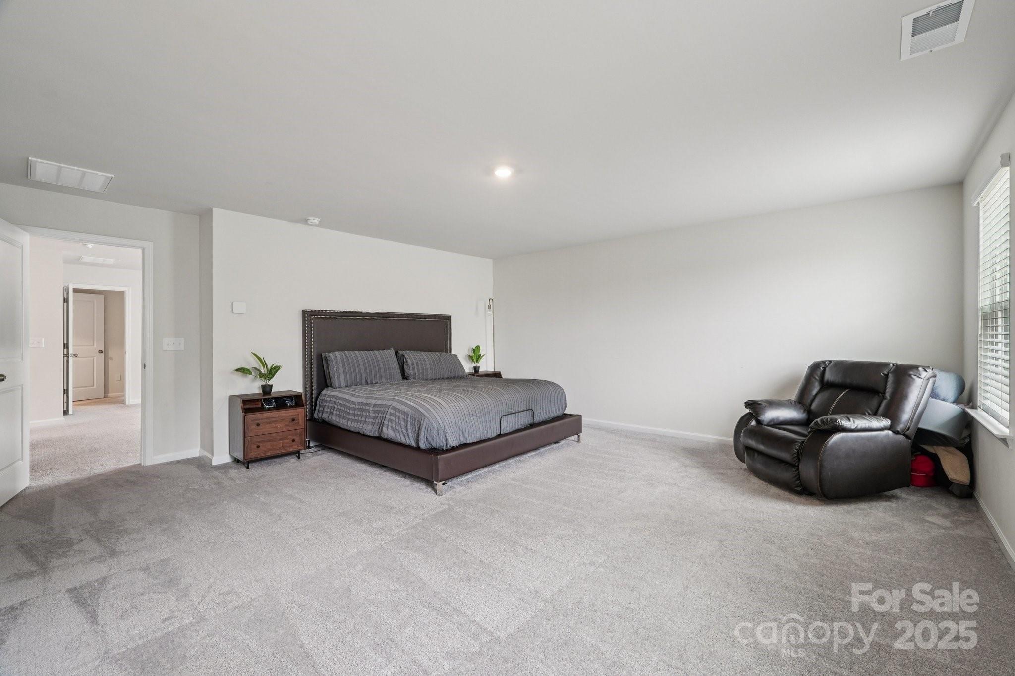 299 Hamptons Cove Road Troutman, NC 28166 - Photo 28 of 40 a bedroom with a bed and gym equipment