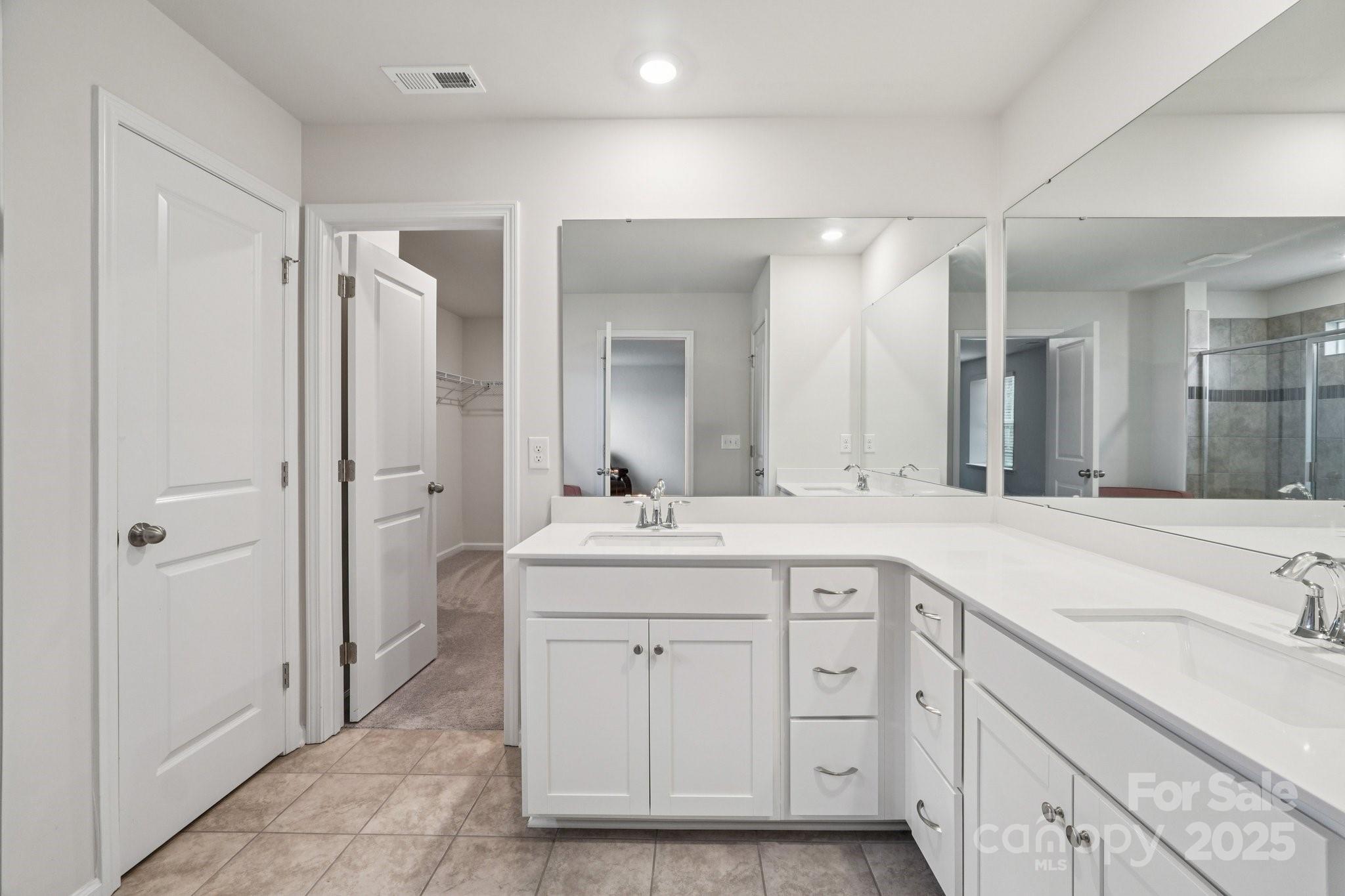 299 Hamptons Cove Road Troutman, NC 28166 - Photo 30 of 40 a spacious bathroom with a granite countertop sink mirror and double