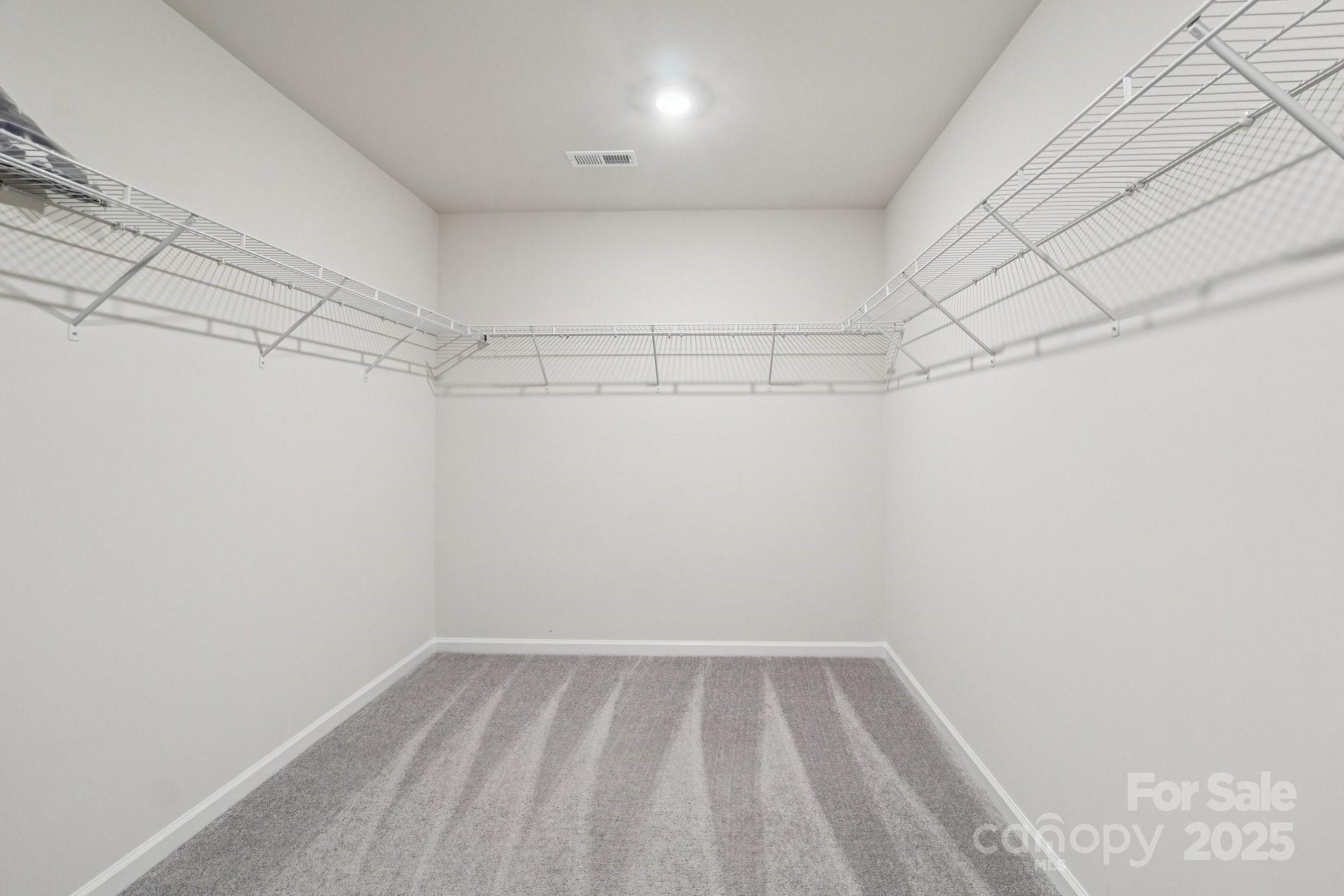 299 Hamptons Cove Road Troutman, NC 28166 - Photo 32 of 40 a view of a room with racks on the wall