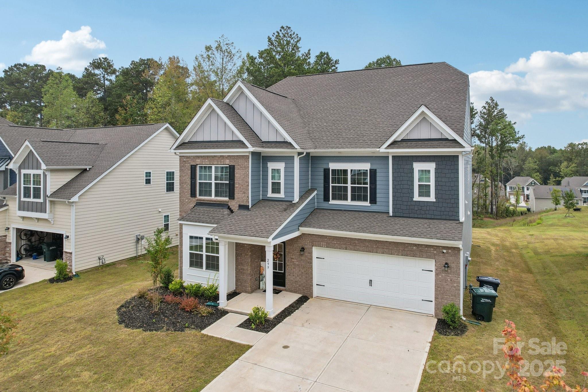 299 Hamptons Cove Road Troutman, NC 28166 - Photo 5 of 40 a house view with a garden space