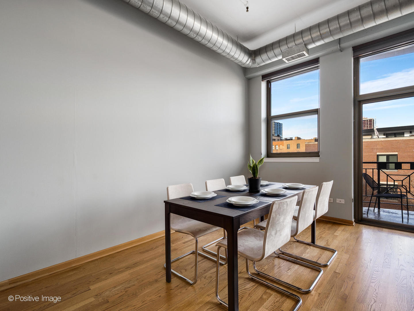1301 West Madison Street, Unit 402 Chicago, IL 60607 - Photo 11 of 22 a dining room with furniture and wooden floor