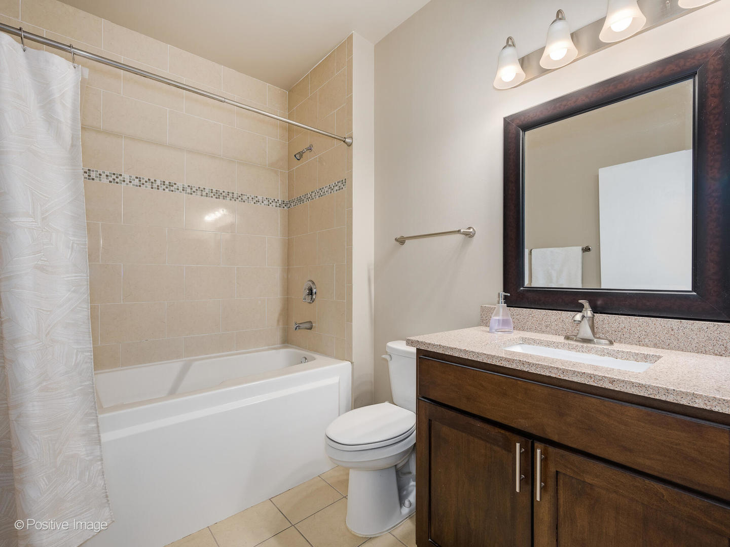 1301 West Madison Street, Unit 402 Chicago, IL 60607 - Photo 14 of 22 a bathroom with a granite countertop sink toilet a large mirror a bathtub and shower