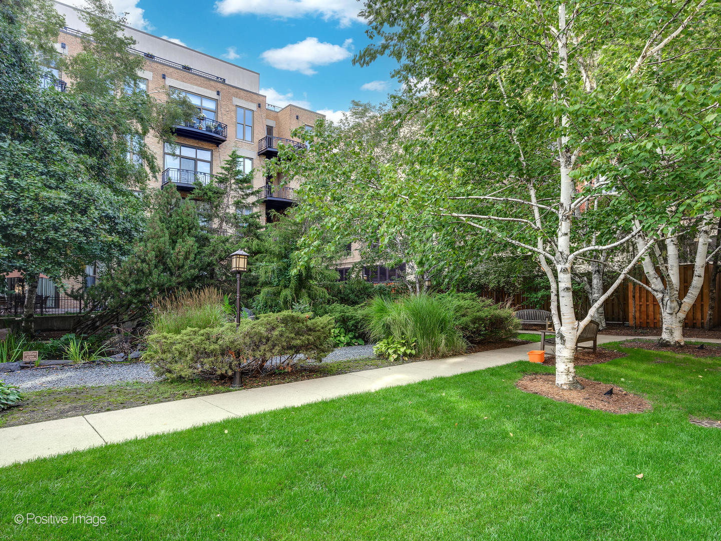 1301 West Madison Street, Unit 402 Chicago, IL 60607 - Photo 19 of 22 a view of a backyard with a garden and trees