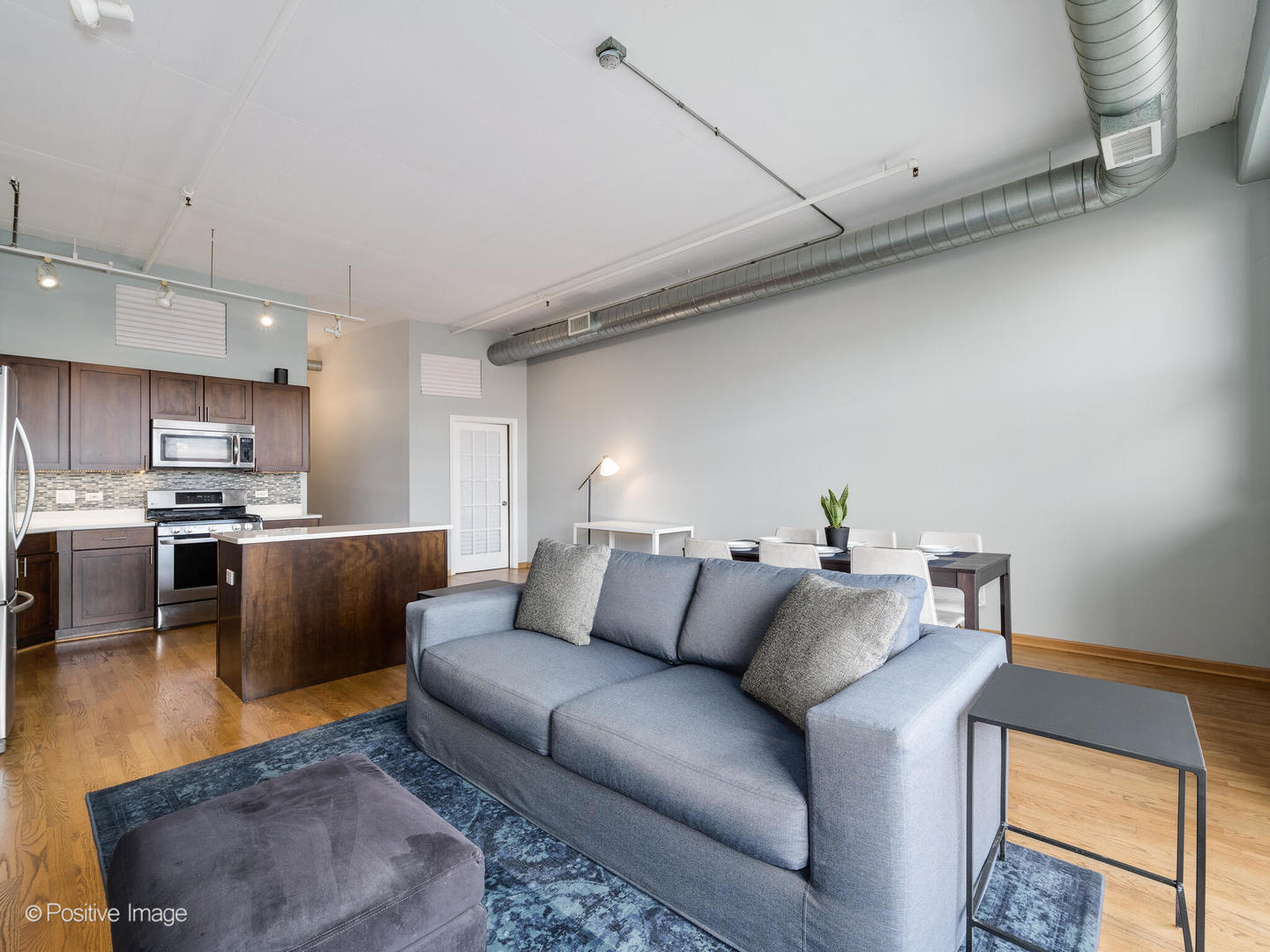 1301 West Madison Street, Unit 402 Chicago, IL 60607 - Photo 10 of 22 a living room with furniture and kitchen view