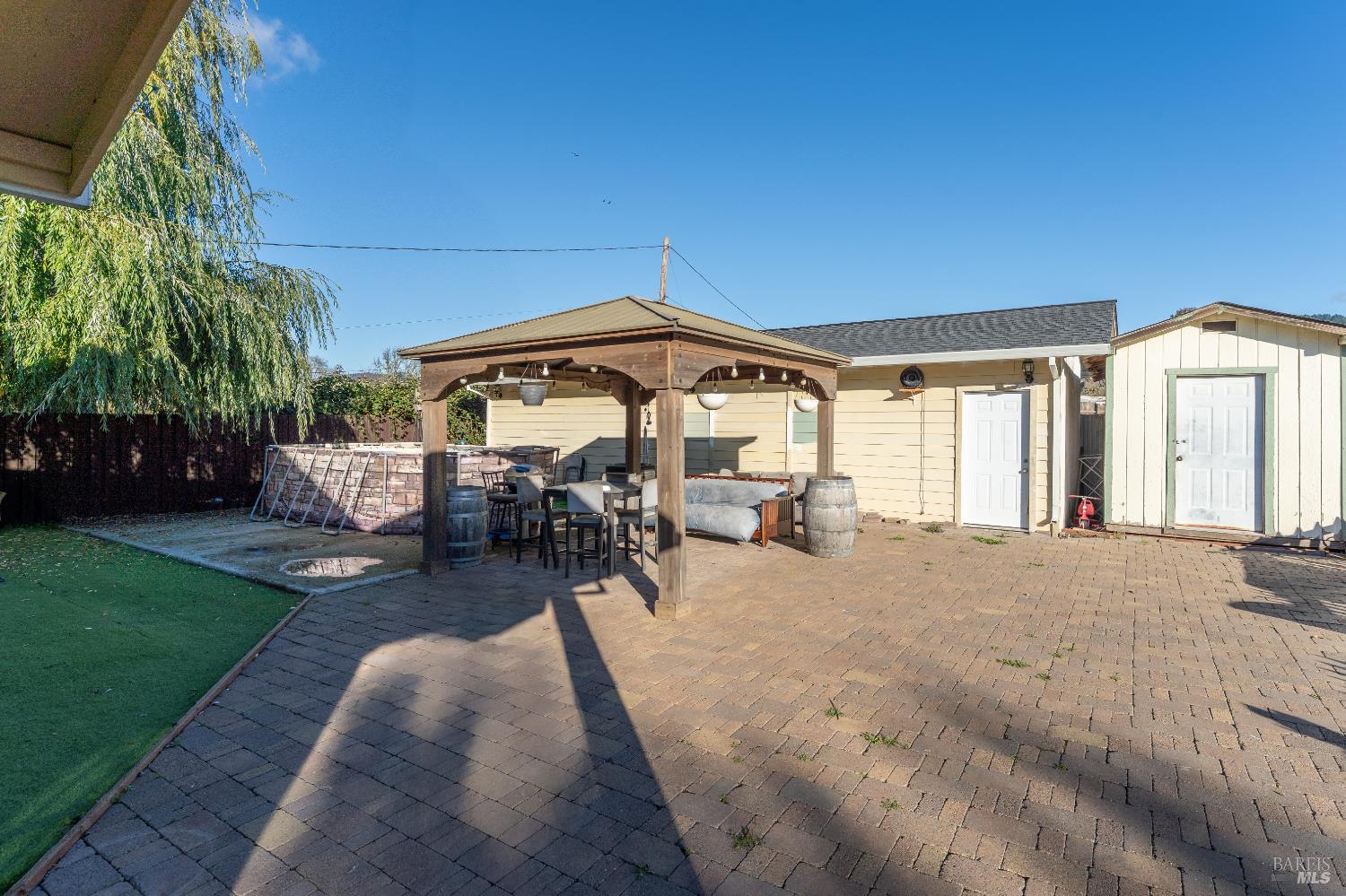 2580 Center Valley Road Willits, CA 95490 - Photo 13 of 43 a patio with a table and chairs under an umbrella