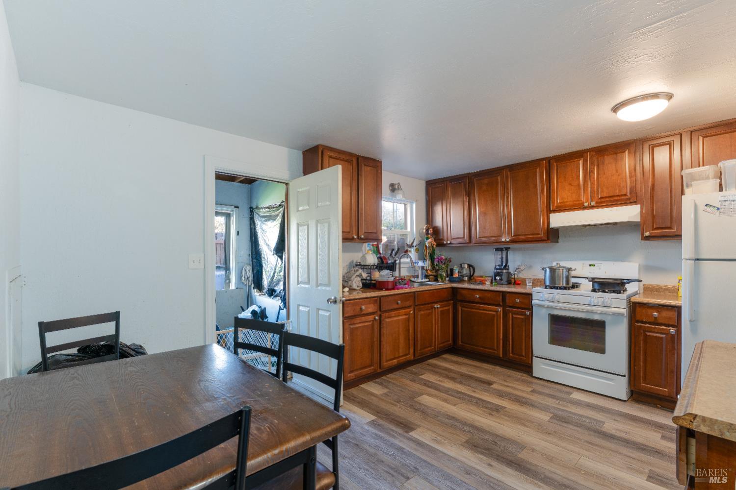 2580 Center Valley Road Willits, CA 95490 - Photo 18 of 43 a kitchen with stainless steel appliances granite countertop a stove refrigerator and cabinets