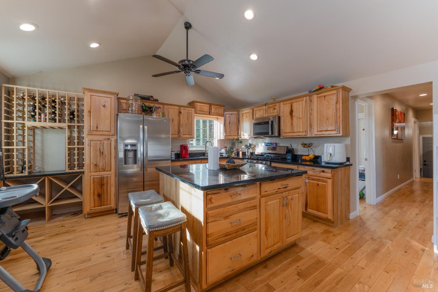 2580 Center Valley Road Willits, CA 95490 - Photo 2 of 43 a kitchen with granite countertop a table chairs refrigerator and microwave