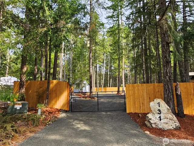 an outdoor sitting area with couch and wooden fence