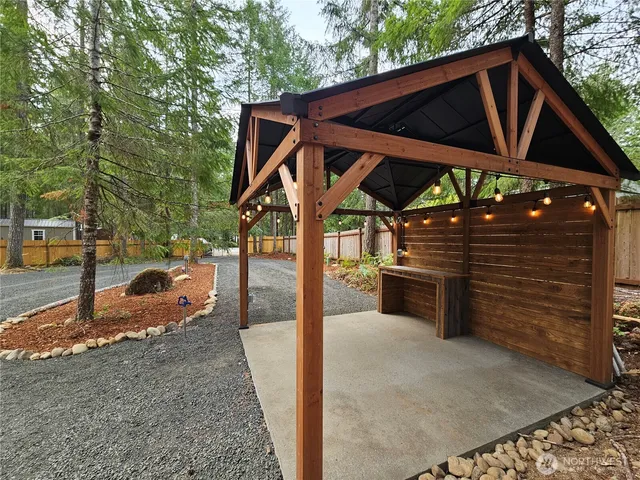 a view of a house with backyard and sitting area