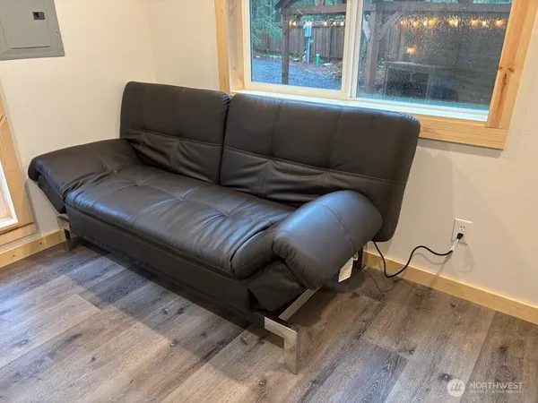 a living room with furniture and a floor to ceiling window