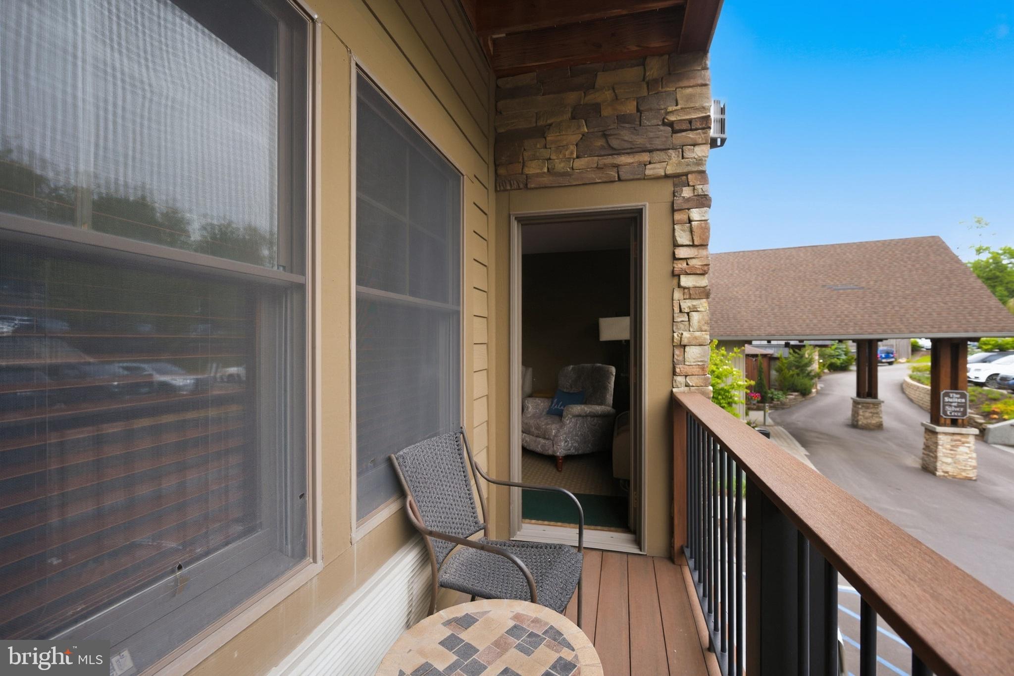 565 Glendale Road, Unit 208A Oakland, MD 21550 - Photo 29 of 51 a balcony with table and chairs