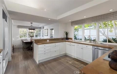 a kitchen with sink cabinets and wooden floor