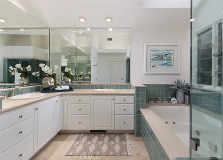 a spacious bathroom with a granite countertop sink mirror and bathtub