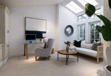 a living room with furniture a rug and a large window