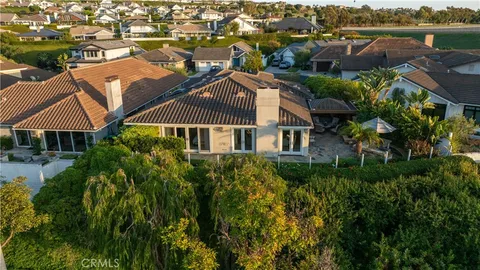 an aerial view of multiple houses with a yard
