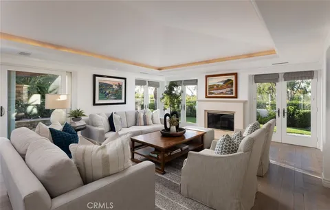 a living room with furniture a large window and a fireplace