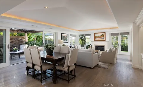 a dining room with furniture and wooden floor