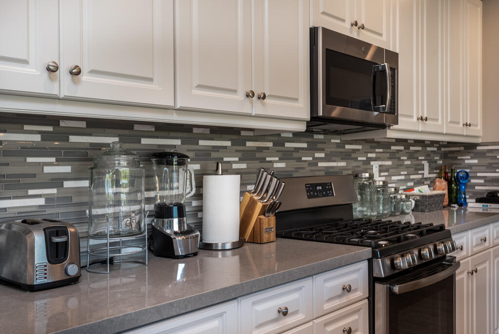 50715 Monterey Cyn Drive Indio, CA 92201 - Photo 19 of 43 a kitchen with a stove and a microwave