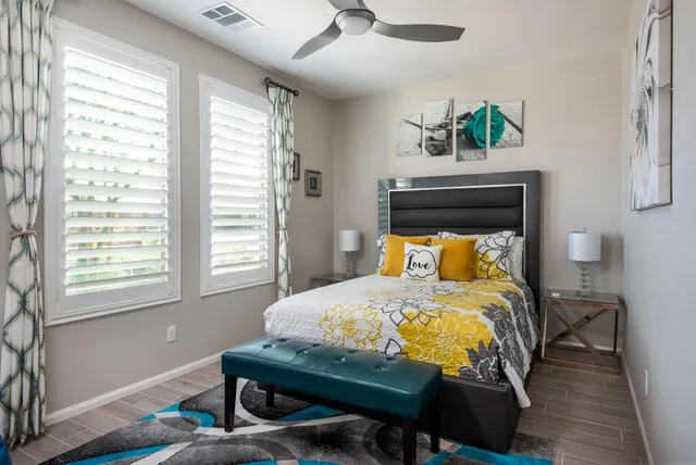 a bedroom with a bed table and window