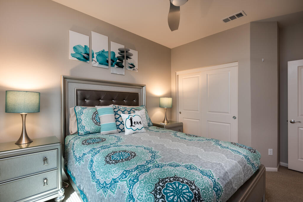 50715 Monterey Cyn Drive Indio, CA 92201 - Photo 7 of 43 a bedroom with a bed and a potted plant