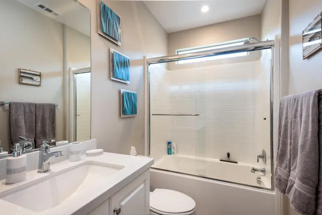a bathroom with a sink toilet tub and shower