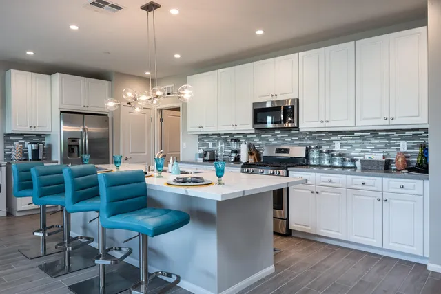 a kitchen with stainless steel appliances kitchen island granite countertop a sink and cabinets