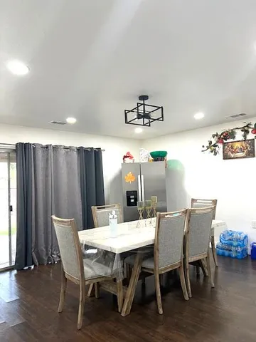a kitchen with a dining table cabinets and stainless steel appliances