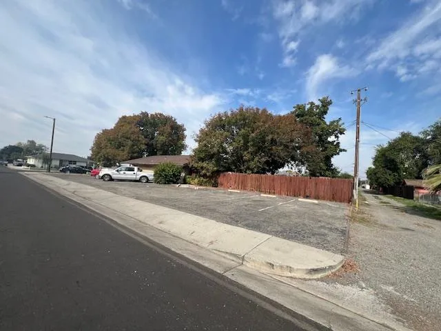 a view of wooden fence next to a road