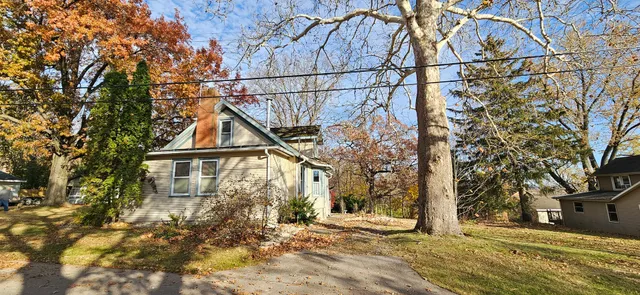 a view of a house with a tree in the background