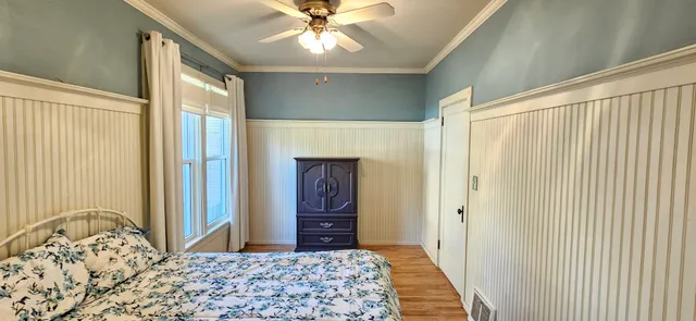 a bedroom with a bed and a dresser