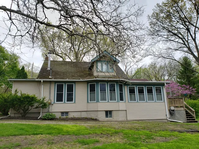 a house that has a tree in front of a house