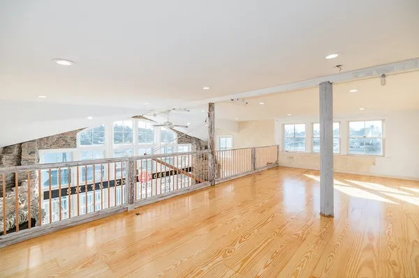 a view of an empty room with wooden floor