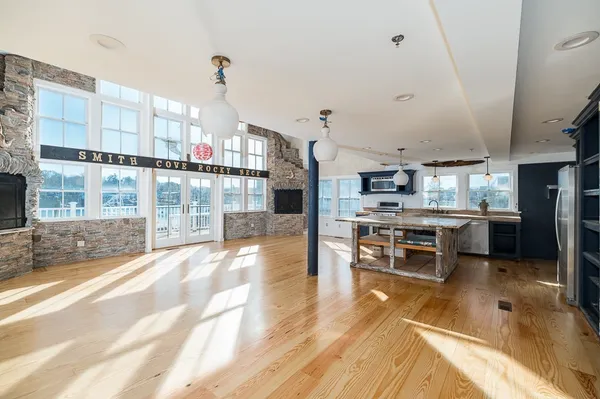 a open kitchen with stainless steel appliances kitchen island granite countertop a sink and cabinets