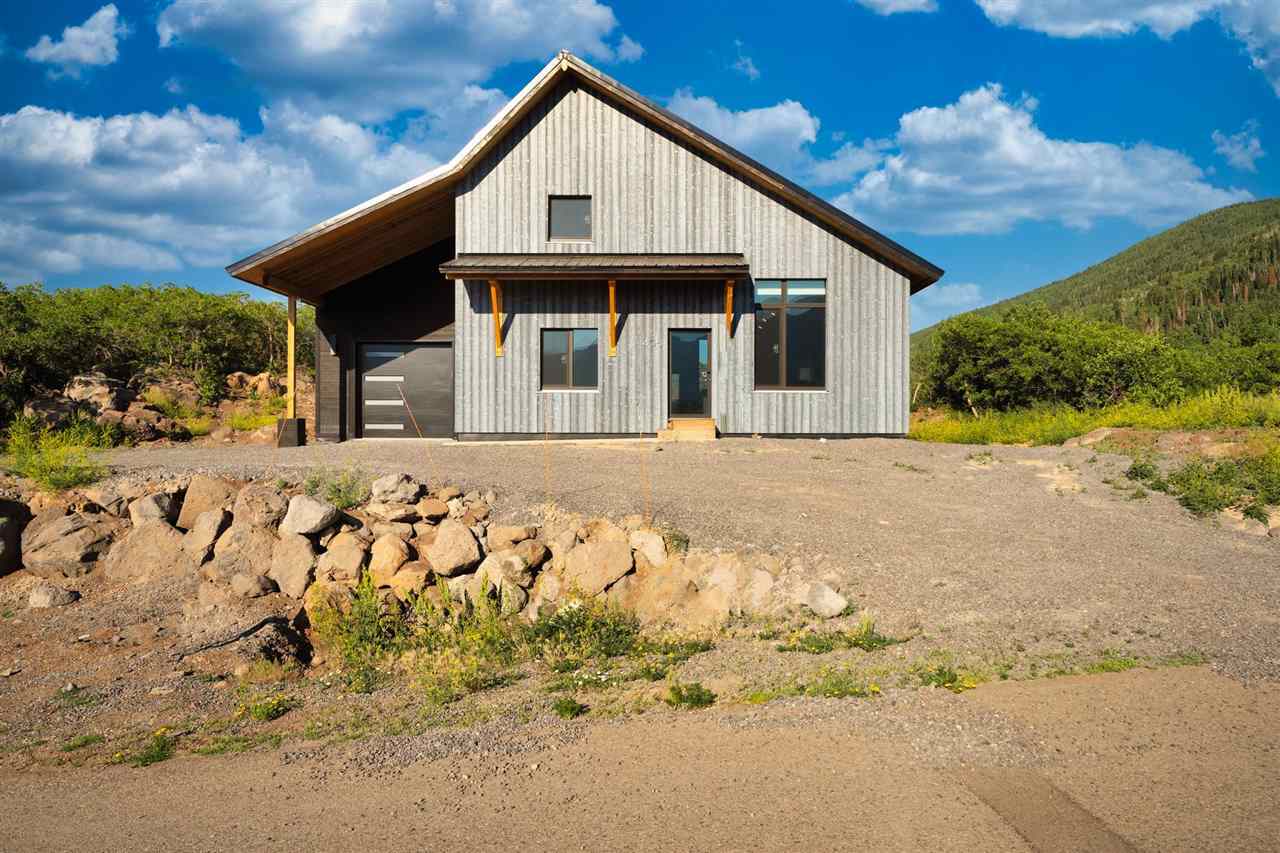 a view of a white house with a yard