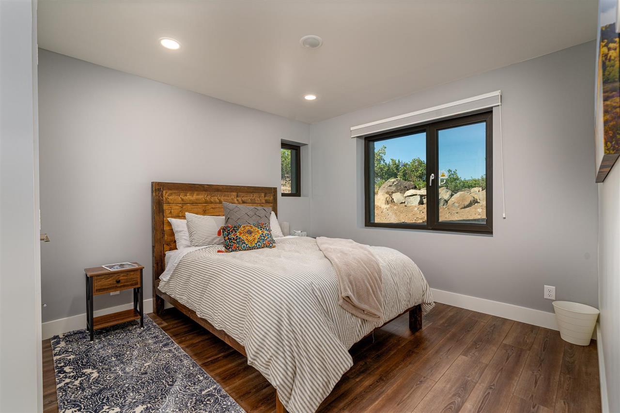 408 Coyote Run Mesa, CO 81643 - Photo 11 of 35 a bedroom with a bed and a painting on the wall