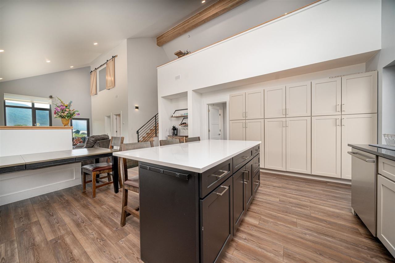 408 Coyote Run Mesa, CO 81643 - Photo 8 of 35 a kitchen with a sink and wooden cabinets