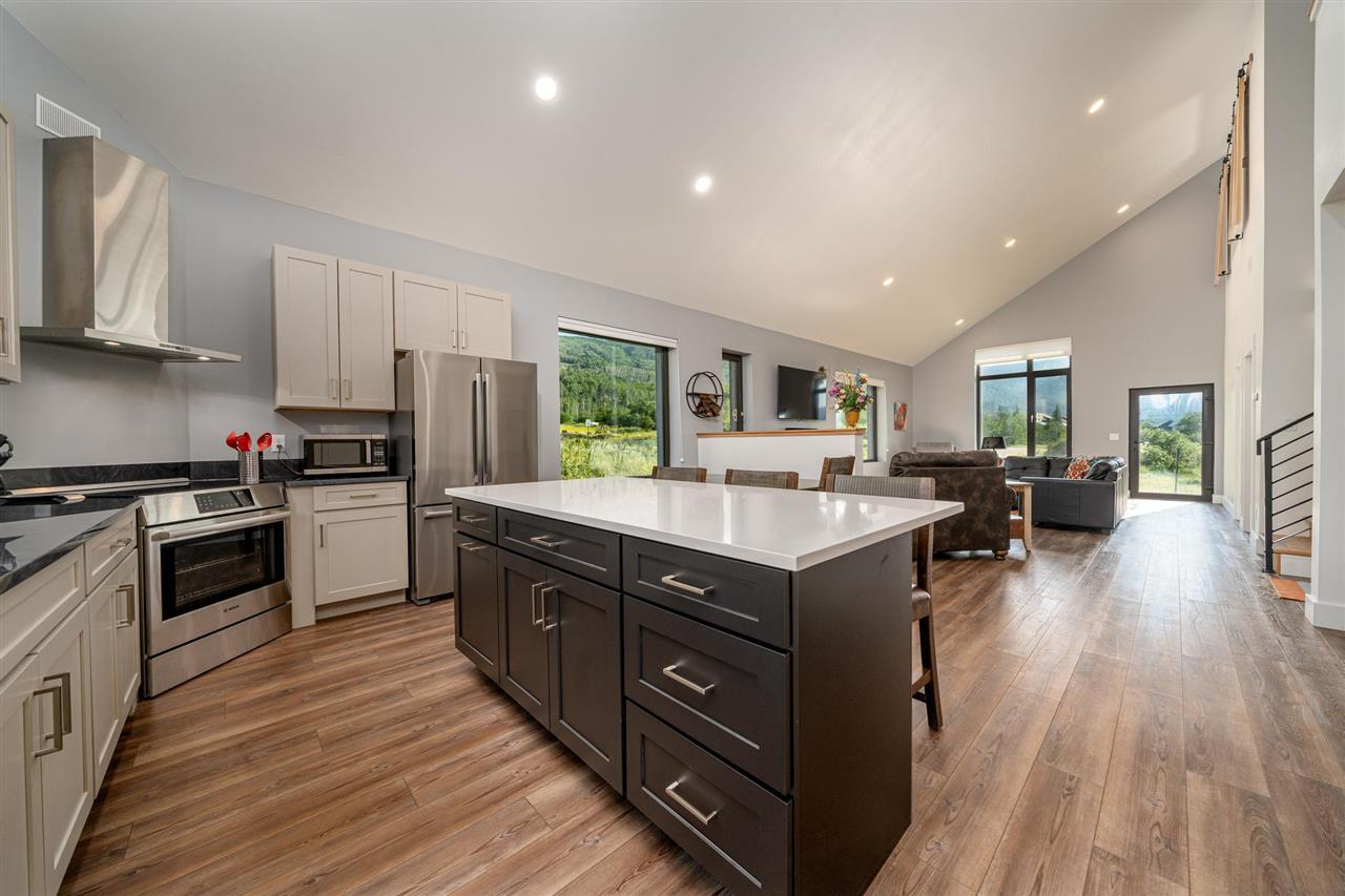 408 Coyote Run Mesa, CO 81643 - Photo 9 of 35 a kitchen with wooden floors and stainless steel appliances