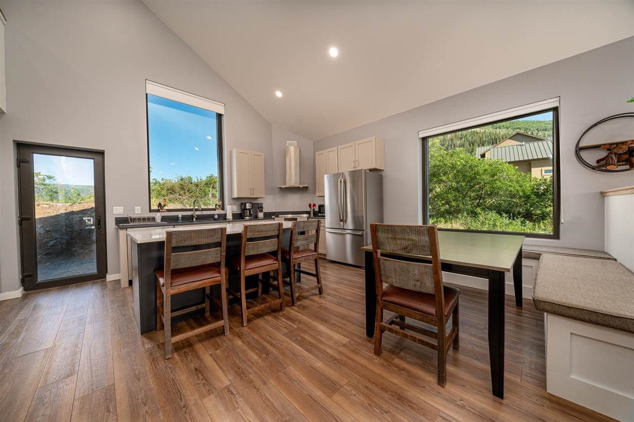 408 Coyote Run Mesa, CO 81643 - Photo 10 of 35 a view of a dining room with furniture window and wooden floor