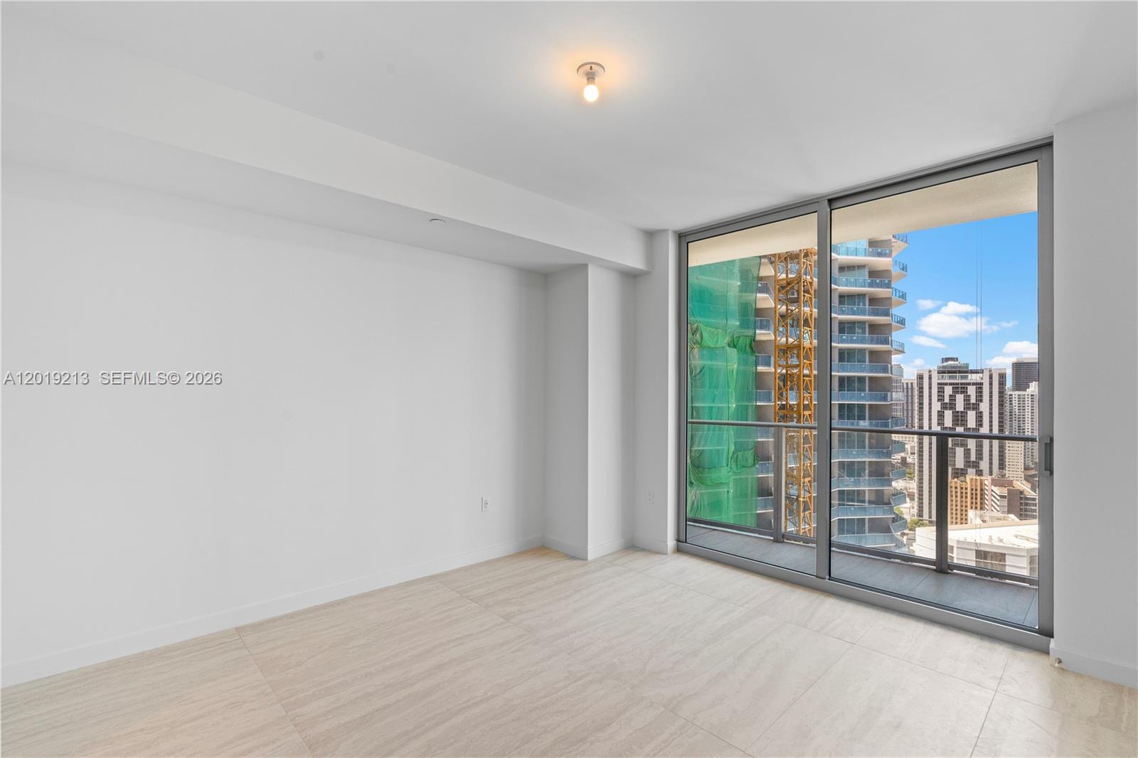 77 Southeast 5th, Unit 3702 Miami, FL 33131 - Photo 28 of 63 a view of an empty room with glass door