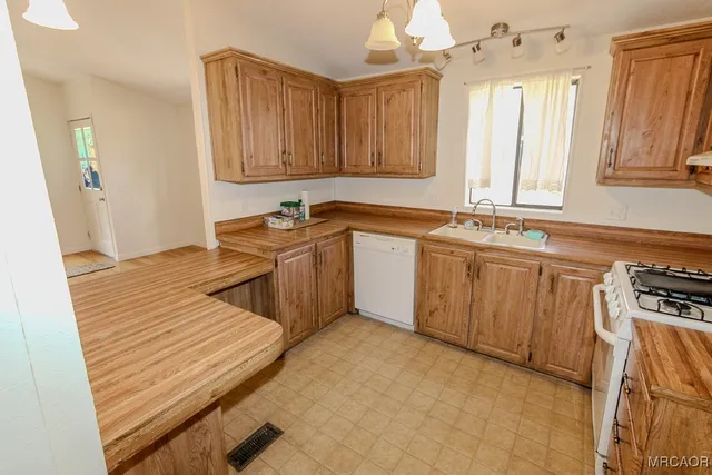 a kitchen with stainless steel appliances a sink stove and cabinets