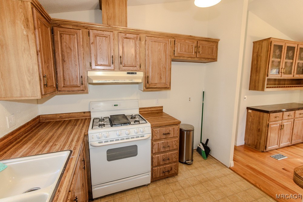 1197 Mitchell Lane Big Bear City, CA 92386 - Photo 12 of 32 a white stove top oven sitting inside of a kitchen