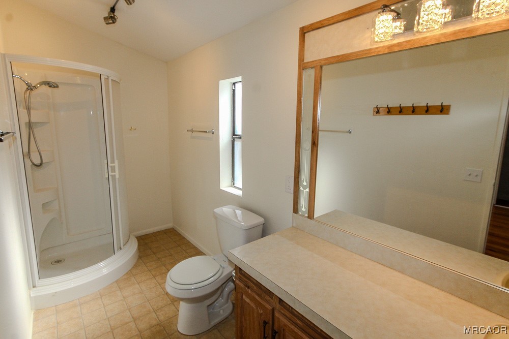 1197 Mitchell Lane Big Bear City, CA 92386 - Photo 24 of 32 a bathroom with a sink a toilet and shower