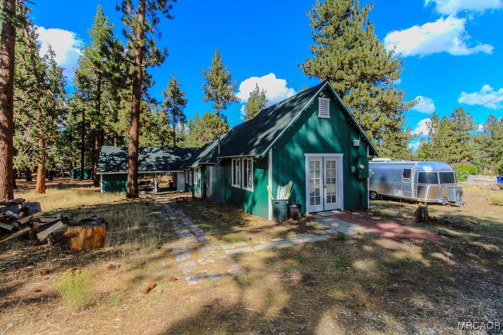 1197 Mitchell Lane Big Bear City, CA 92386 - Photo 29 of 32 a front view of a house with a yard