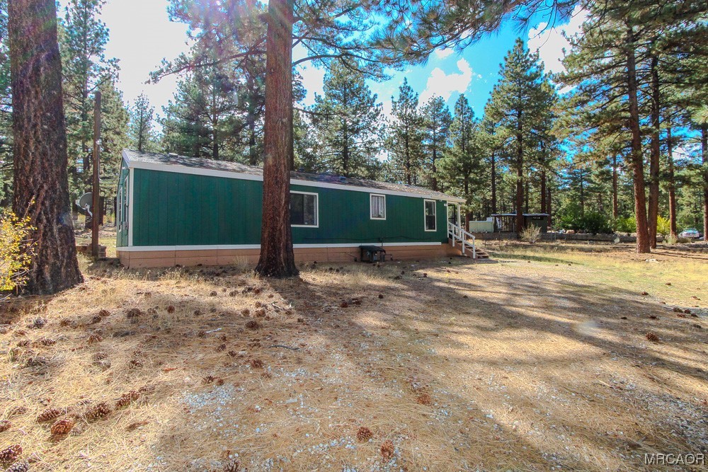 1197 Mitchell Lane Big Bear City, CA 92386 - Photo 30 of 32 a front view of a house with a yard