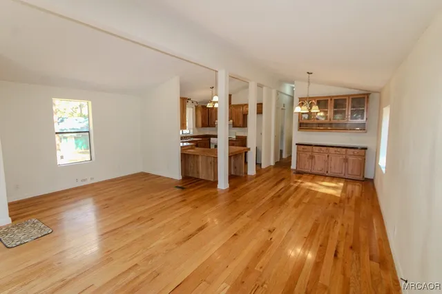 a view of a kitchen with a stove cabinets and wooden floor