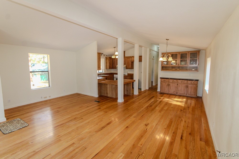 1197 Mitchell Lane Big Bear City, CA 92386 - Photo 5 of 32 a view of a kitchen with a stove cabinets and wooden floor