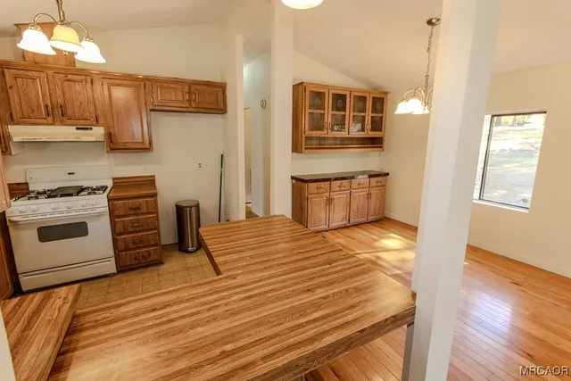 a kitchen with stainless steel appliances granite countertop a stove and a refrigerator