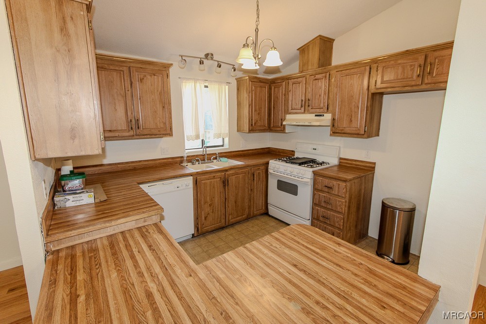 1197 Mitchell Lane Big Bear City, CA 92386 - Photo 10 of 32 a view of a kitchen with wooden floor and electronic appliances