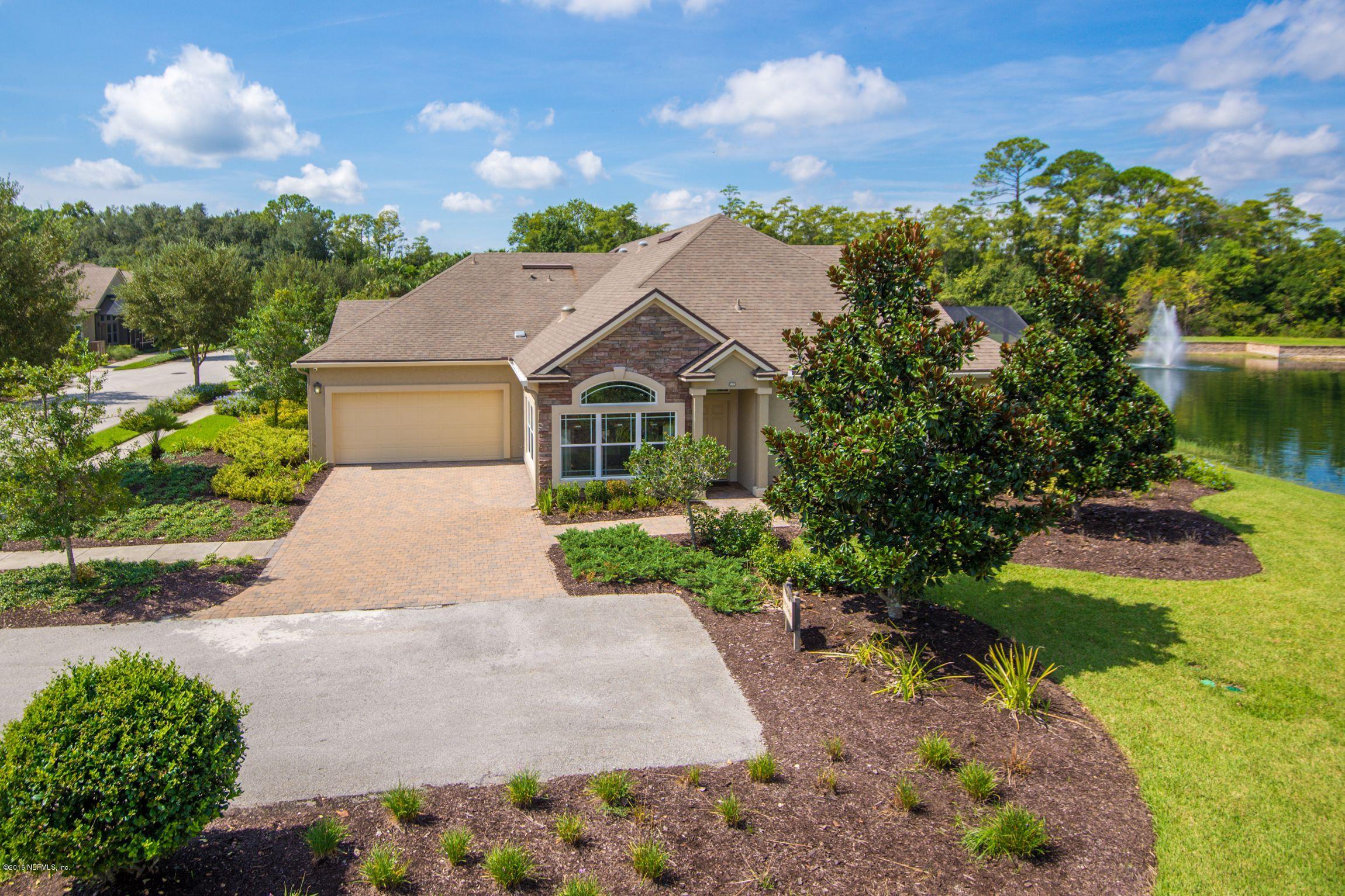 a aerial view of a house with a yard and a garden