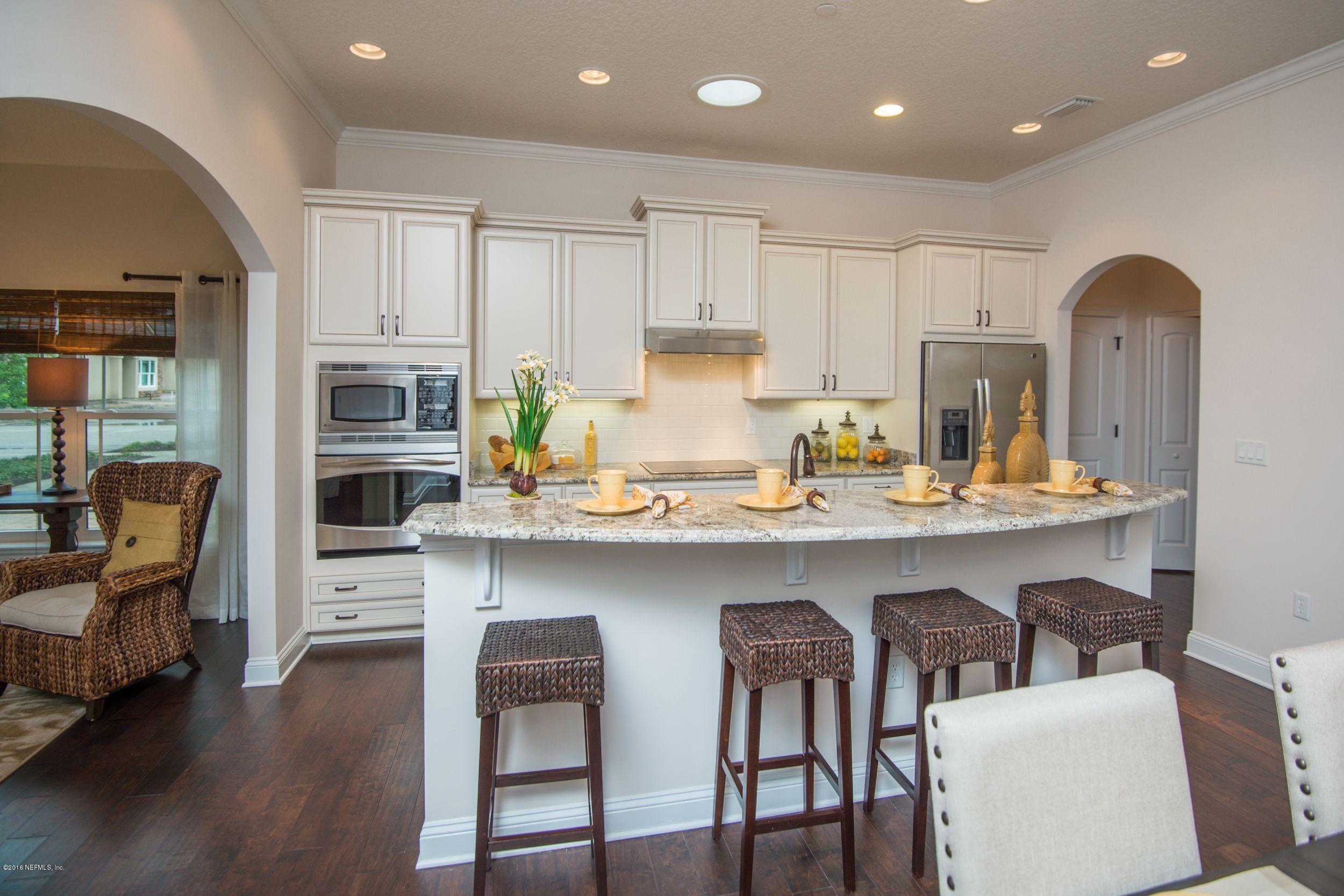 84 Ocale Court St. Augustine, FL 32084 - Photo 5 of 21 a kitchen with stainless steel appliances granite countertop a table chairs microwave and sink